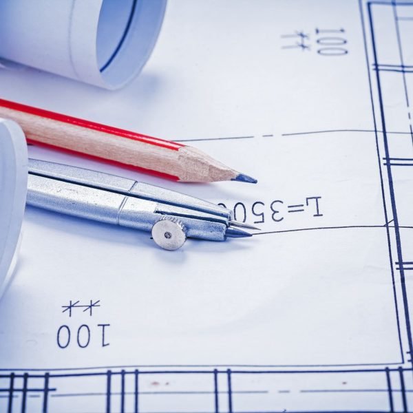 rolled-blueprints-pencil-compass-close-up-2026-01-11-09-25-05-utc